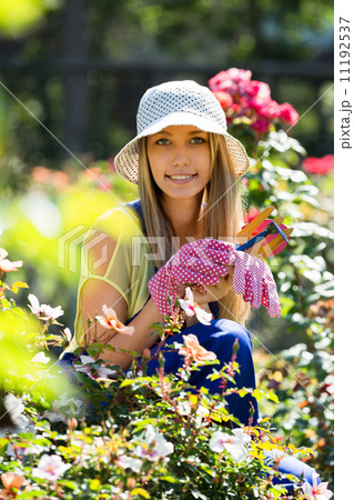 Happy young girl in uniform at yard gardening 11192537