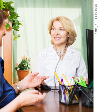 Elderly doctor having good news for a person 11193050