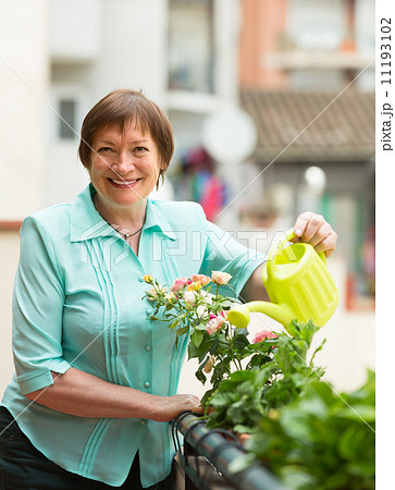 Woman watering plants on balcony 11193102