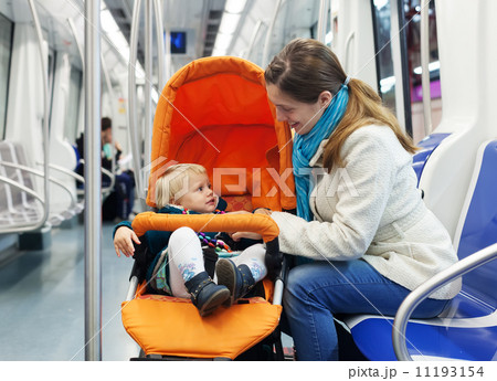 woman with baby in stroller at subway woman with baby in stroller at subway 11193154