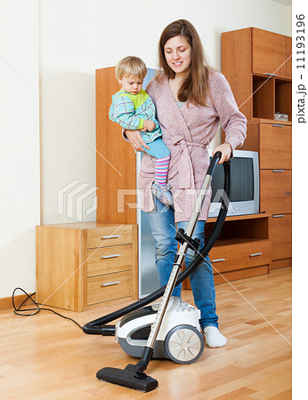 Mother with baby cleaning home Mother with baby cleaning home 11193196
