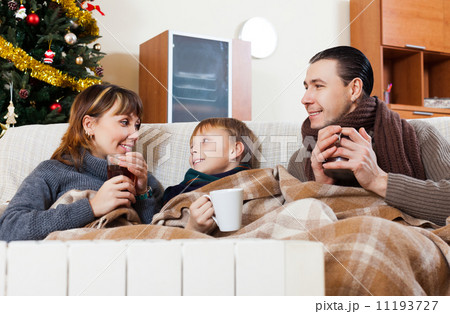 Happy family on sofa at Christmas time Happy family on sofa at Christmas time 11193727