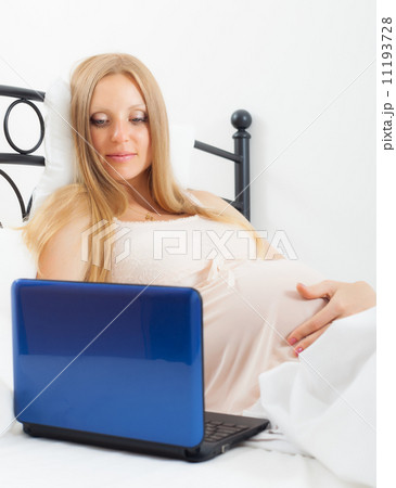 long-haired pregnant woman with laptop long-haired pregnant woman with laptop 11193728
