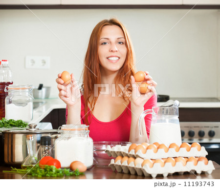 housewife with eggs in home kitchen 11193743