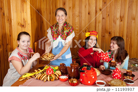 Women drinks tea and eats pancakes Women drinks tea and eats pancakes 11193937