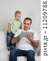 Dad and son watching tablet 11209788