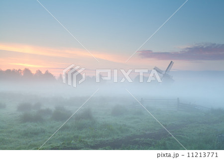 windmill silhouette in dense morning fog windmill silhouette in dense morning fog 11213771