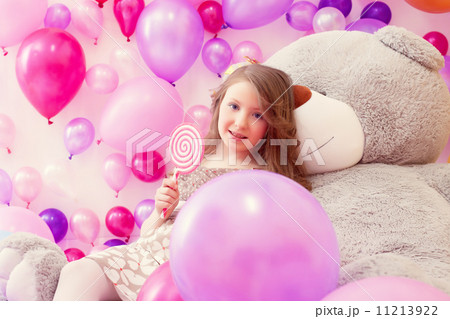 Cute girl with lollipop posing looking at camera Cute girl with lollipop posing looking at camera 11213922