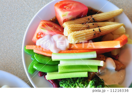 fresh vegetable salad on white disc, close-up 11216336