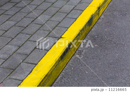 Yellow curb line on the road Yellow curb line on the road 11216665