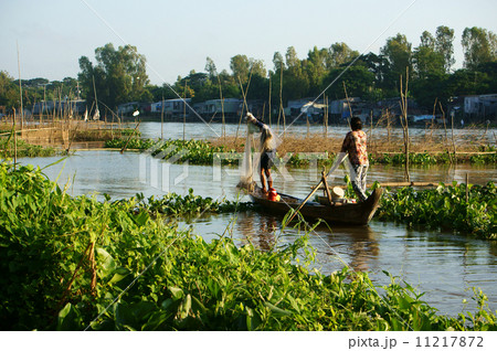 fisherman rowing row boat to catch fish on river 11217872