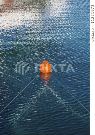 orange buoy in blue ocean water 11221973