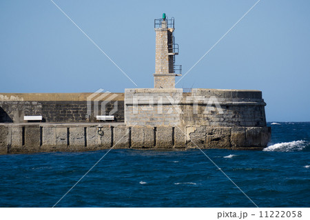 Stone Lighthouse over ocean and blue sky 11222058