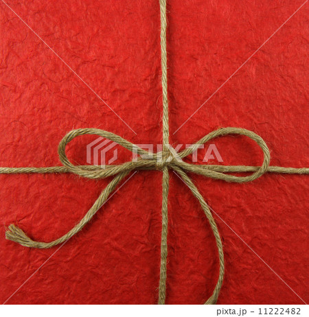String tied in a bow on red paper 11222482
