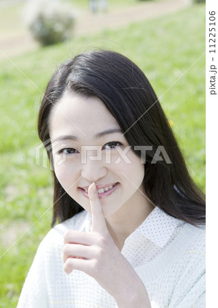 公園で微笑む若い女性 11225106