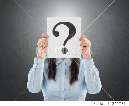 Young woman holding interrogation symbol in front of her face Young woman holding interrogation symbol in front of her face 11225721