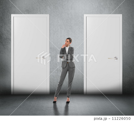 Businesswoman choosing right door 11226050