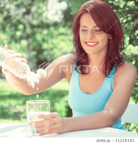 Portrait of young beautiful woman drinking water on picnic Portrait of young beautiful woman drinking water on picnic 11226181