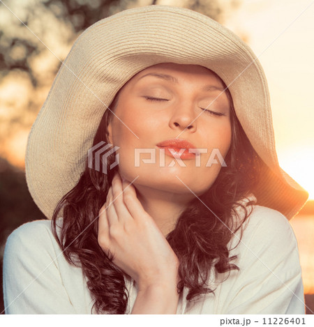 Romantic girl on the beach during sunset 11226401