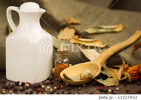 Spices in the spoon with jar of olive oil 11227632