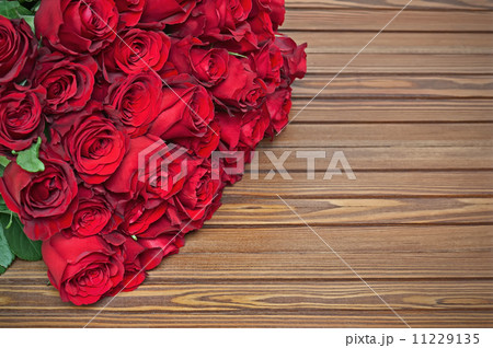 Colorful flower bouquet from red roses on wooden background. Colorful flower bouquet from red roses on wooden background. 11229135