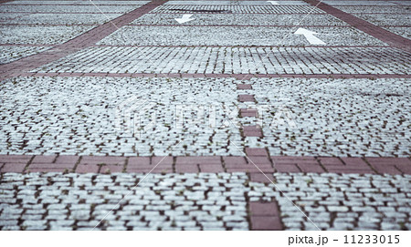 cobblestone pavement with white arrows 11233015