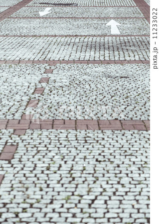 cobblestone pavement with white arrows cobblestone pavement with white arrows 11233022