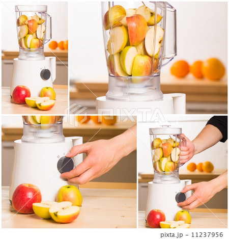 White blender with apples on a wooden table. 11237956