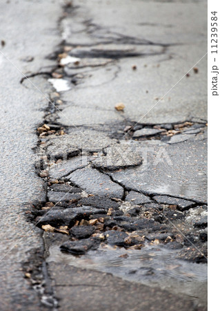 Broken pavement and pothole asphalt road after winter. Broken pavement and pothole asphalt road after winter. 11239584