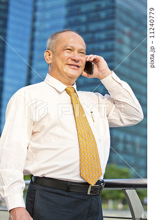Elderly businessman making a call on smart phone 11240779
