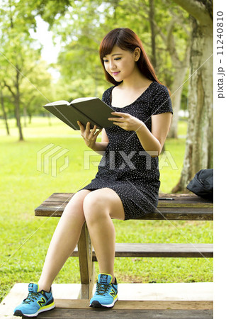 Beautiful young teenage female student studying and writing in park bench Beautiful young teenage female student studying and writing in park bench 11240810