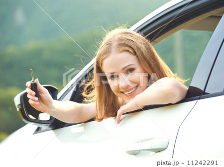 woman driver with keys driving a new car woman driver with keys driving a new car 11242291
