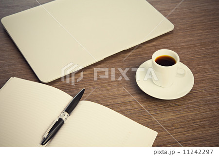 work desk with a cup of coffee computer laptop, notebook, pen 11242297