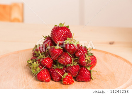 Fresh, juicy strawberries on a wood table Fresh, juicy strawberries on a wood table 11245258