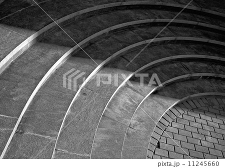 Six curved footsteps made of stone with shadow walking across it Six curved footsteps made of stone with shadow walking across it 11245660