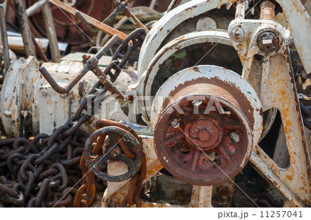 Fragment of rusted bow anchor winch on abandoned ship 11257041