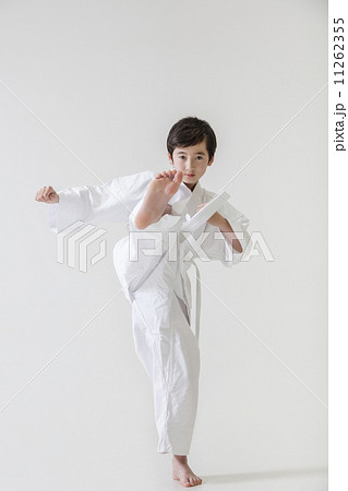 足を蹴り上げる男の子の写真素材