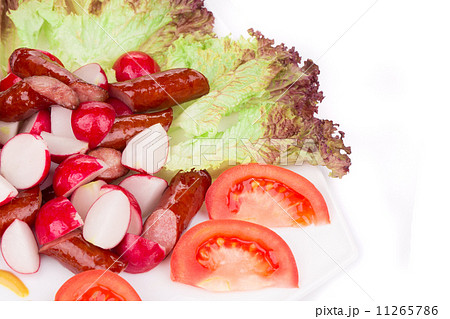 Radish salad with tomatoes and grilled sausages. Radish salad with tomatoes and grilled sausages. 11265786