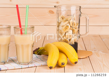 Banana juice and blender full of sliced fruits. Banana juice and blender full of sliced fruits. 11266259