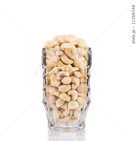 Glass full of tasty cashew nuts. Glass full of tasty cashew nuts. 11266540