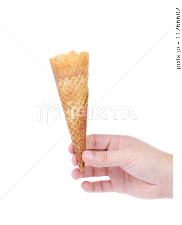Hand holds empty ice cream corn. Hand holds empty ice cream corn. 11266602