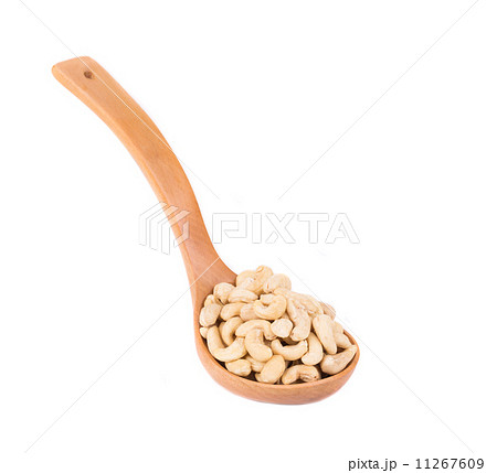 Wooden spoon full of cashew nuts. Wooden spoon full of cashew nuts. 11267609