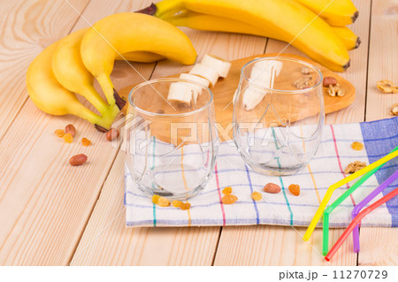 Bananas and glasses on the wood floor. Bananas and glasses on the wood floor. 11270729