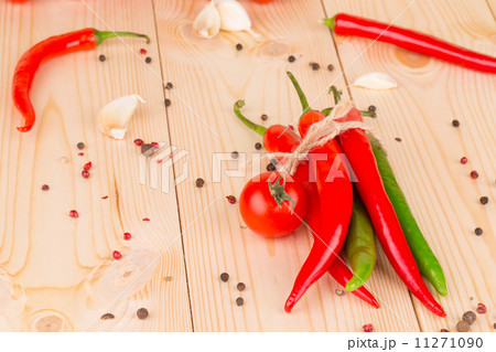 Hot chili pepper on wooden texture. 11271090