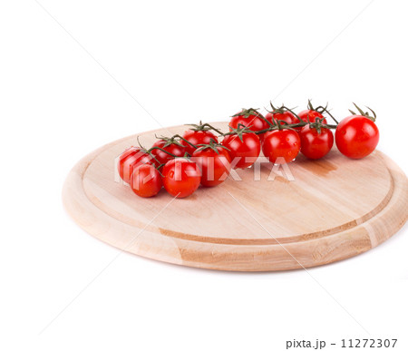Tomatoes on wooden platter. 11272307