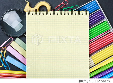 school stationery laid out on the notepad 11278875