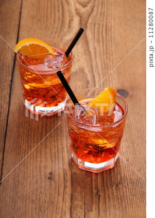 Spritz aperitif, two orange cocktail with ice cubes 11280087