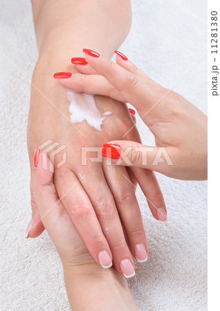 beauty salon, hands massage with moisturizing cream 11281380