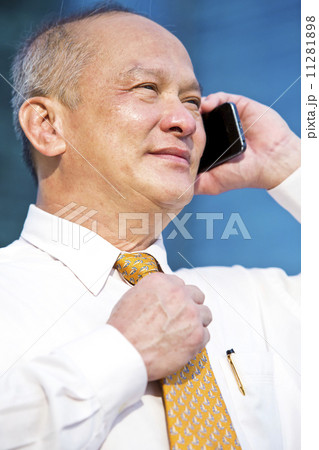 Senior business executive talking on smart phone Senior business executive talking on smart phone 11281898