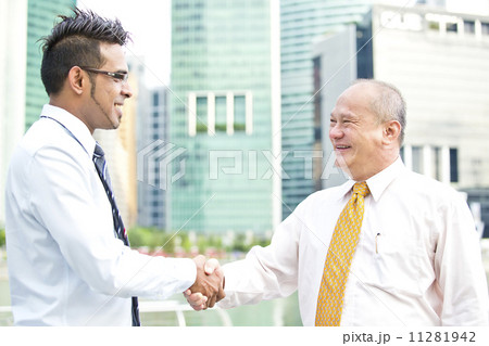 Multi-racial business executive handshake  11281942
